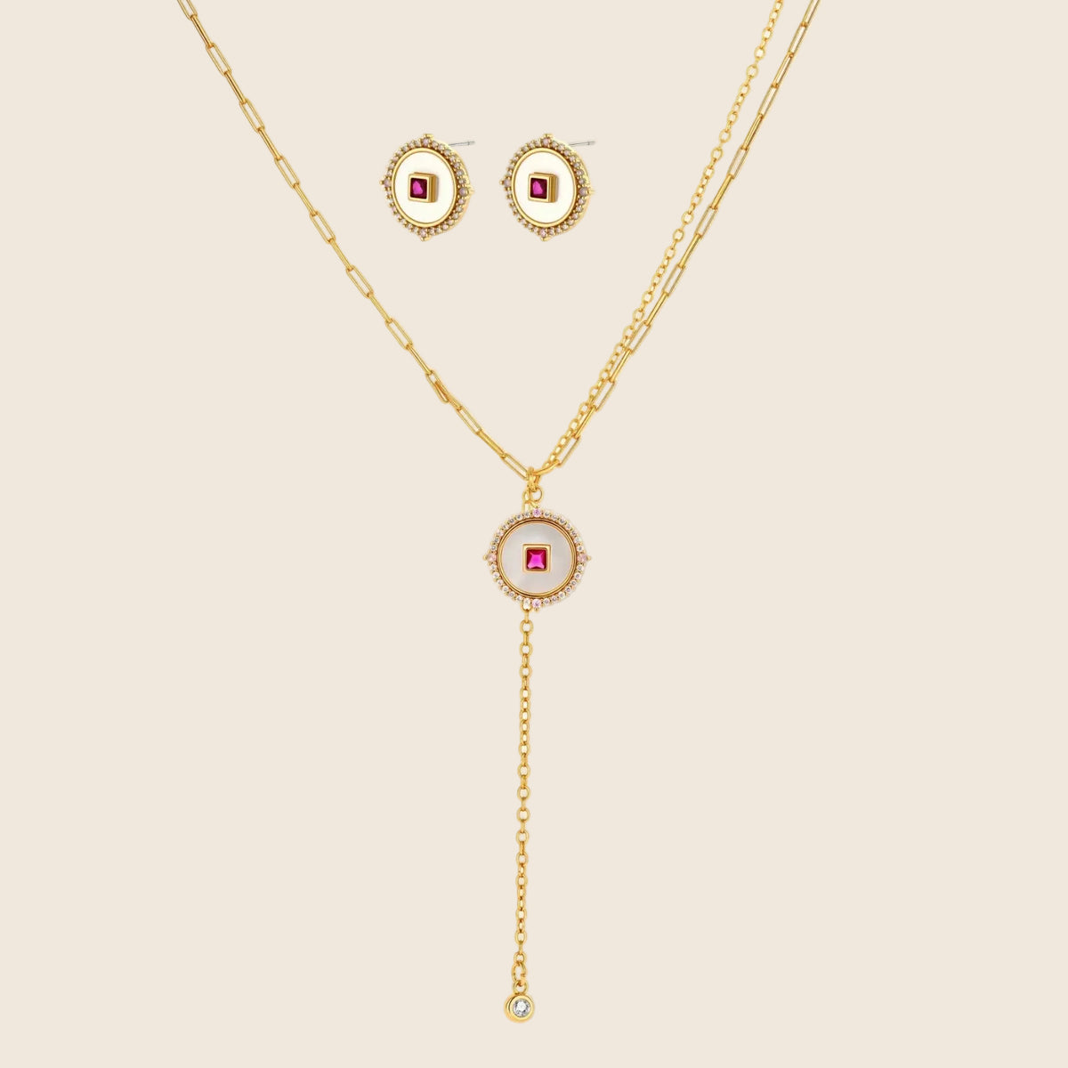 Gold-plated circular medallion necklace set with white enamel base and pink cubic zirconia accent stones