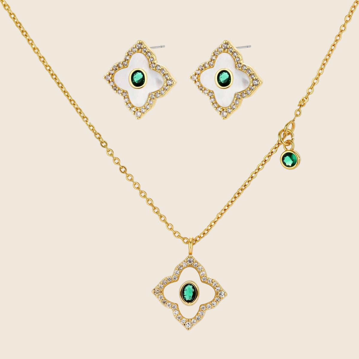 Gold-plated jewelry set with diamond-shaped pendants featuring white centers, green stones, and sparkling zirconia borders