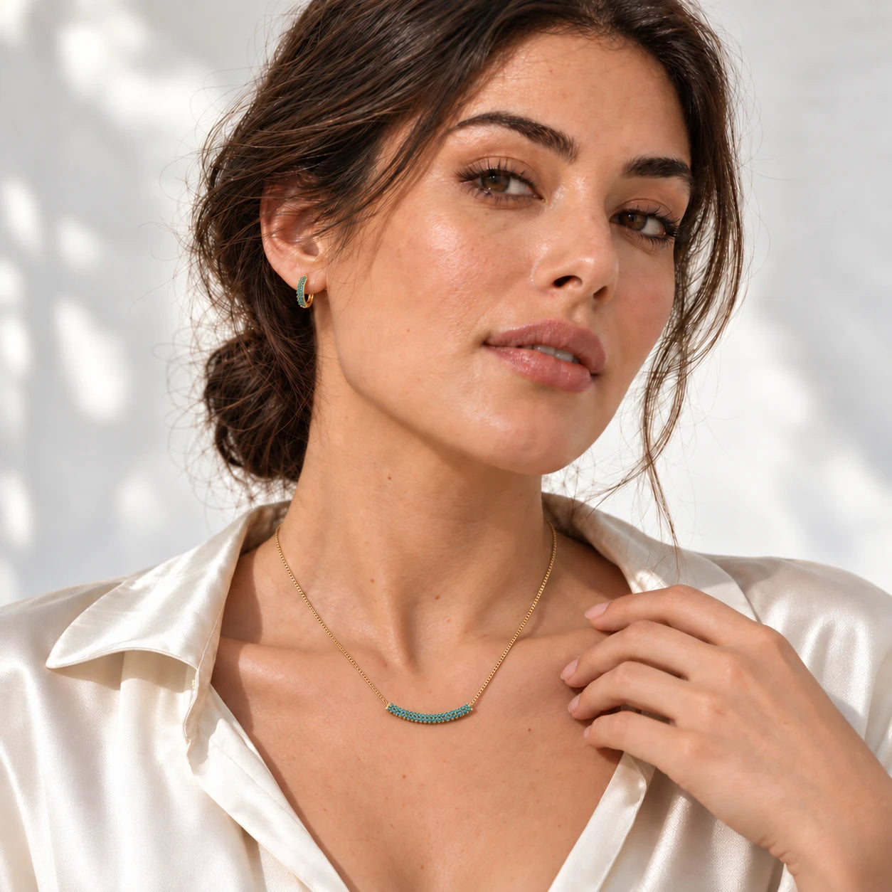 Model wearing the Azura jewellery set with a white shirt