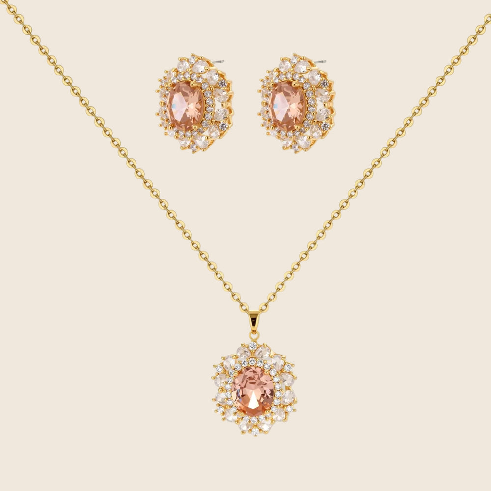 Ornate gold-plated jewelry set featuring peach center stone surrounded by clear AAA cubic zirconia crystals
