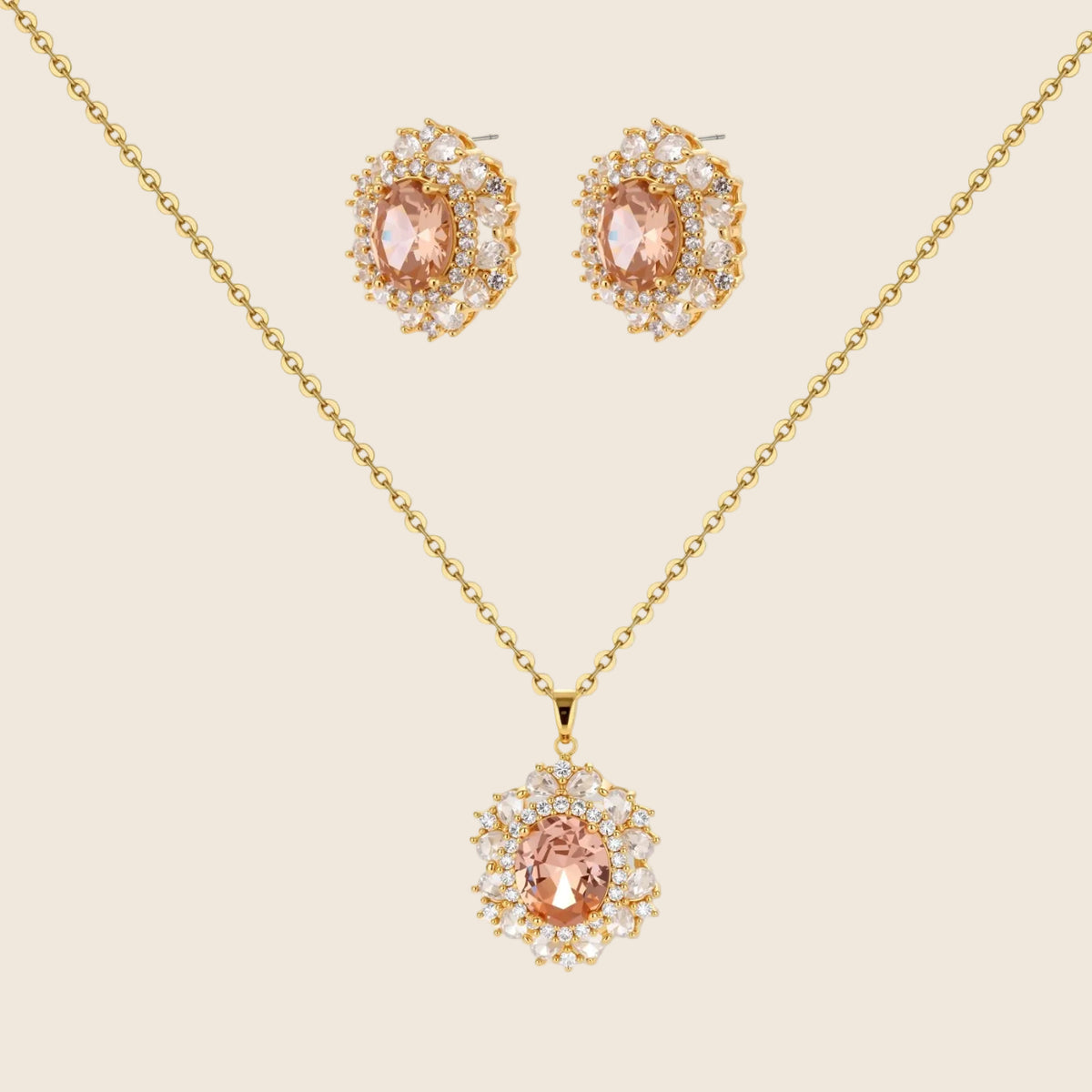 Ornate gold-plated jewelry set featuring peach center stone surrounded by clear AAA cubic zirconia crystals