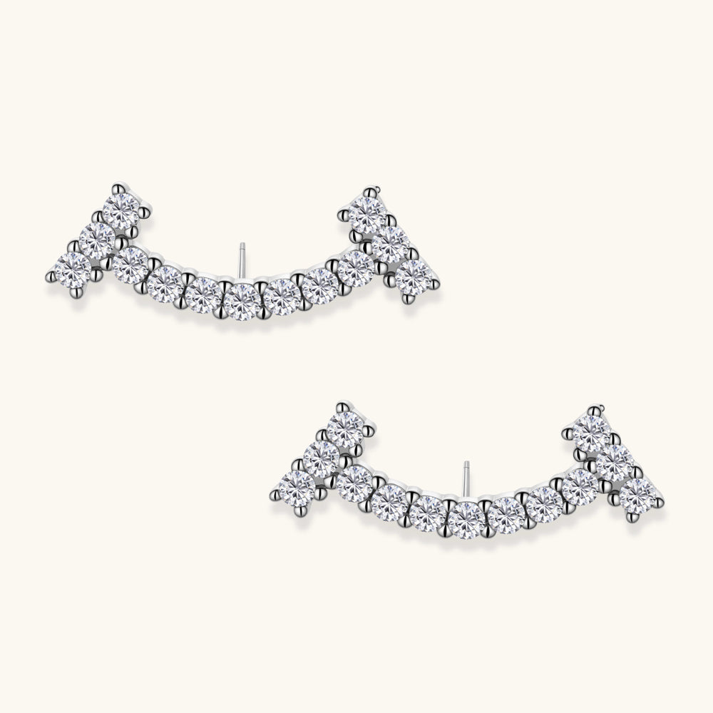 Curved sterling silver ear climbers with moissanite stones arranged in elegant arc shape on white background