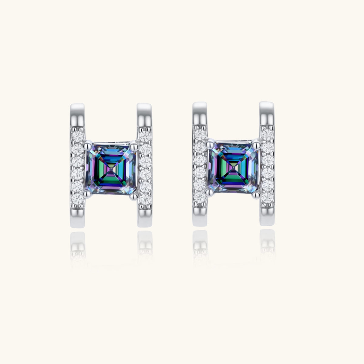 Square moissanite studs in sterling silver geometric setting showing rainbow prismatic fire on white background.