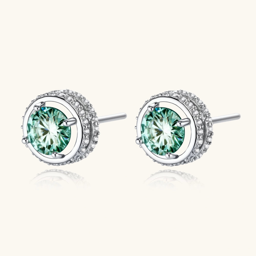 Round green moissanite stud earrings in sterling silver halo settings with brilliant sparkle on white background.