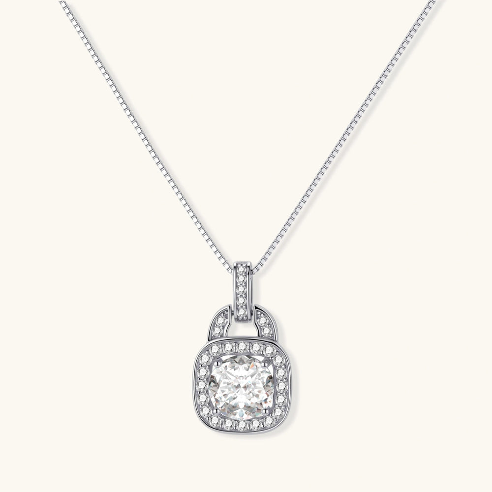 Sterling silver cushion halo pendant necklace featuring 2ct moissanite center stone with delicate box chain on neutral background.