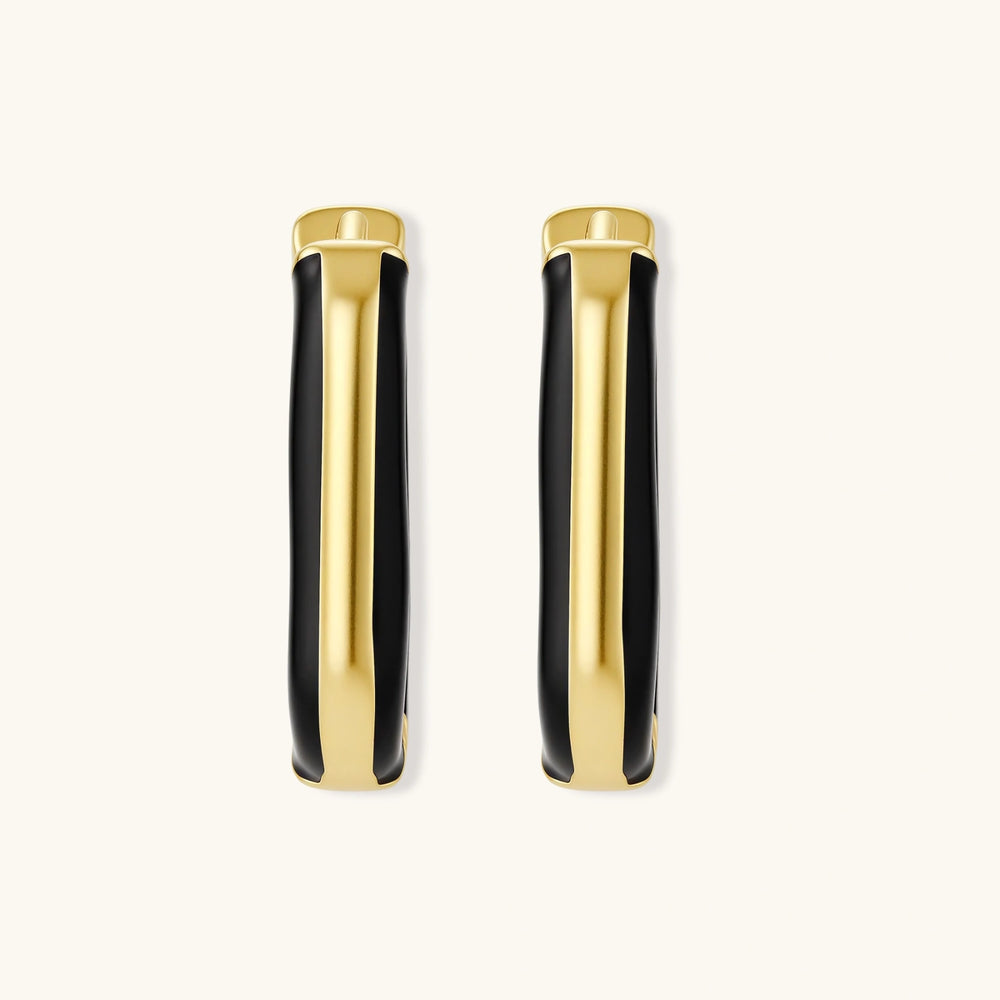 Modern hoop earrings with gold-plated and black sections, featuring hinged closure on white background.