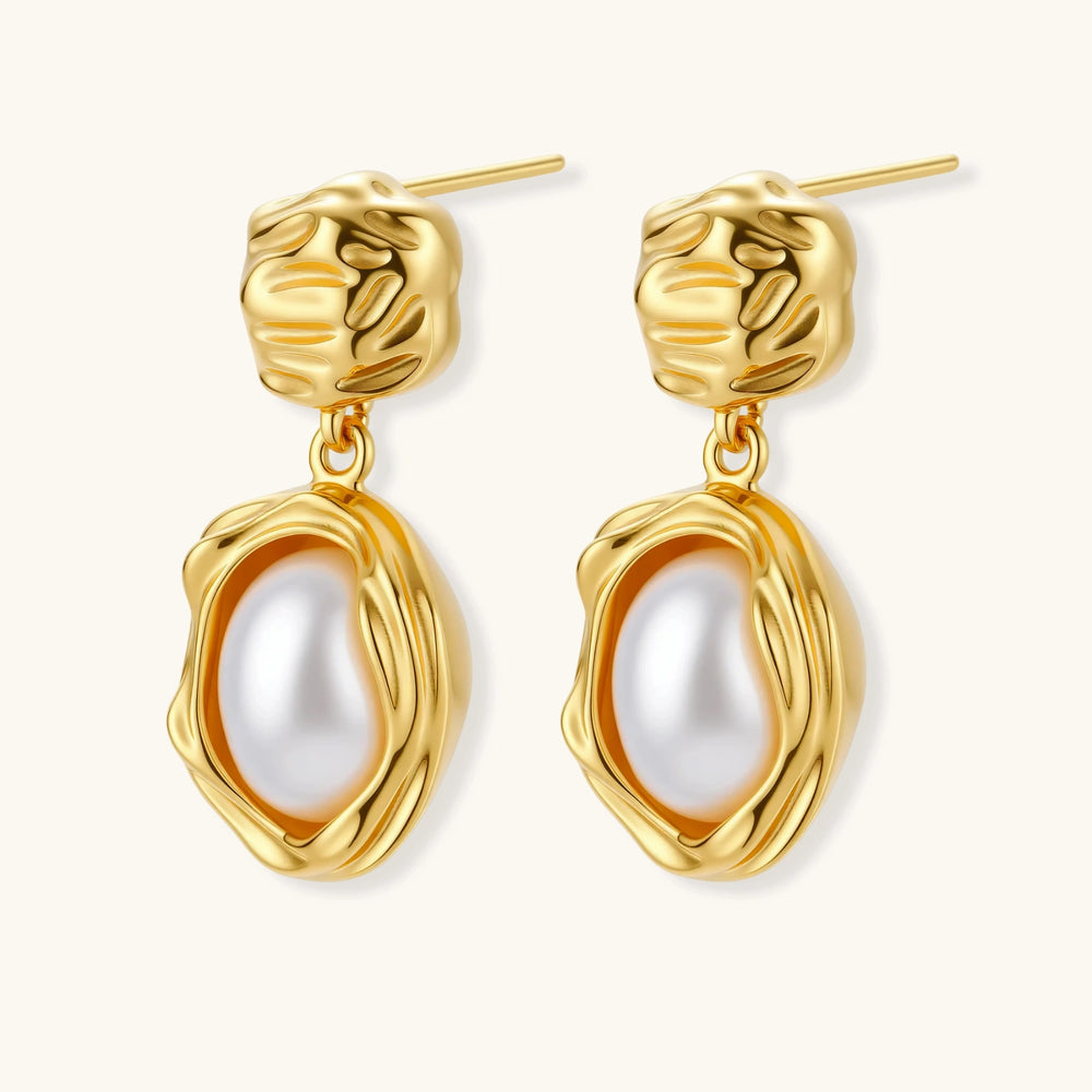 Gold-plated textured stud earrings with white freshwater pearl drops against cream background, showing organic rippled design