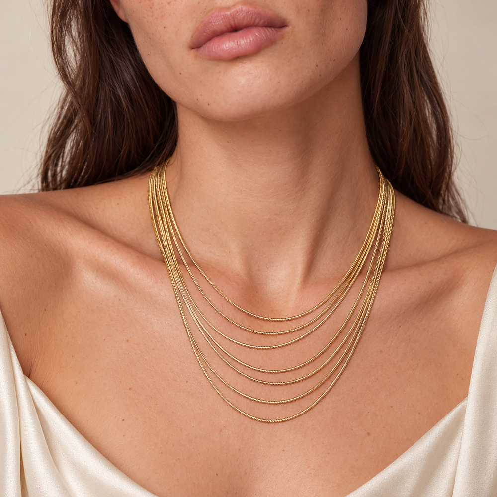 Close-up showing how the seven fine chains of the Golden Hour Layers Necklace sit along the neckline.