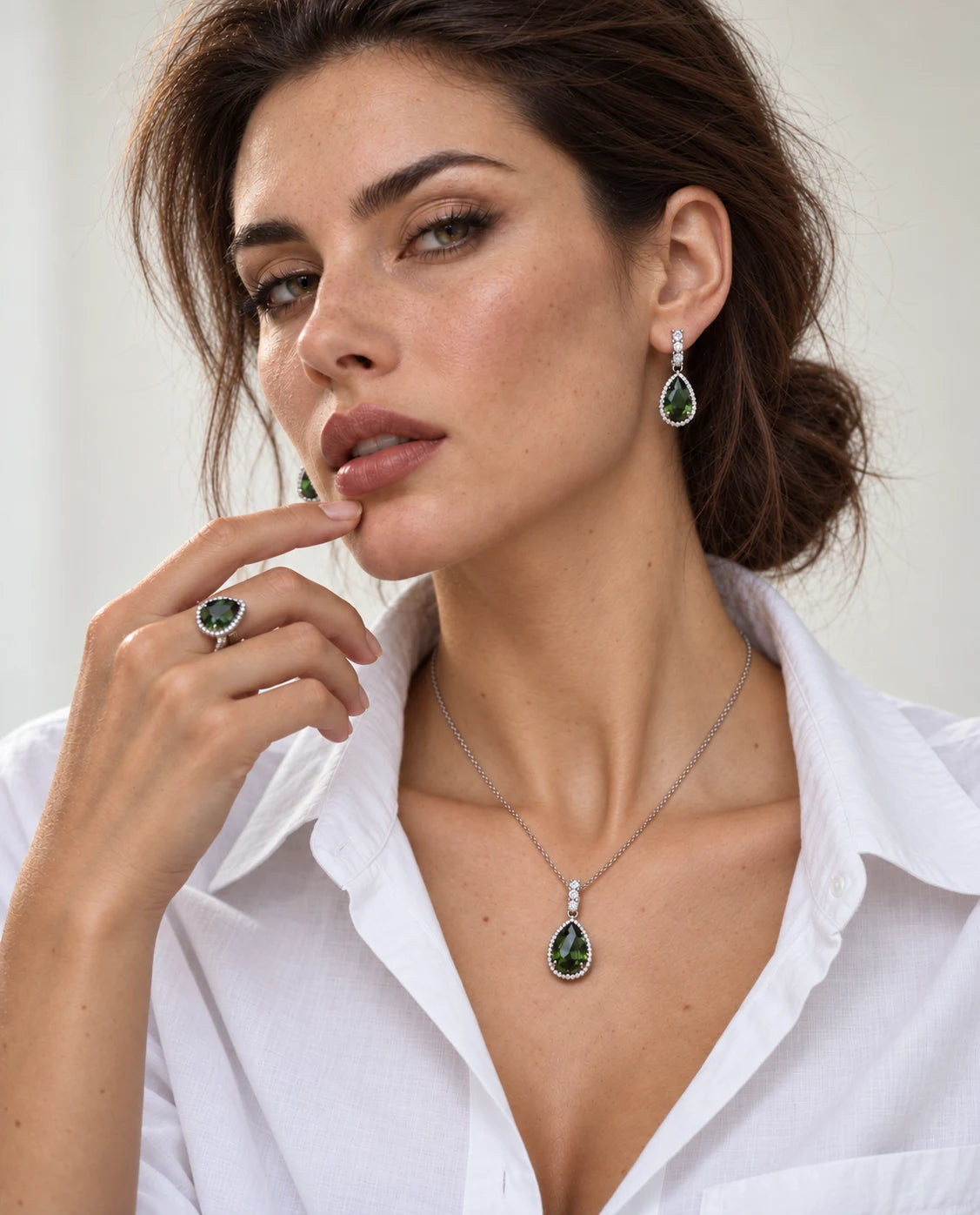 Model wearing the Verde necklace, earrings and ring